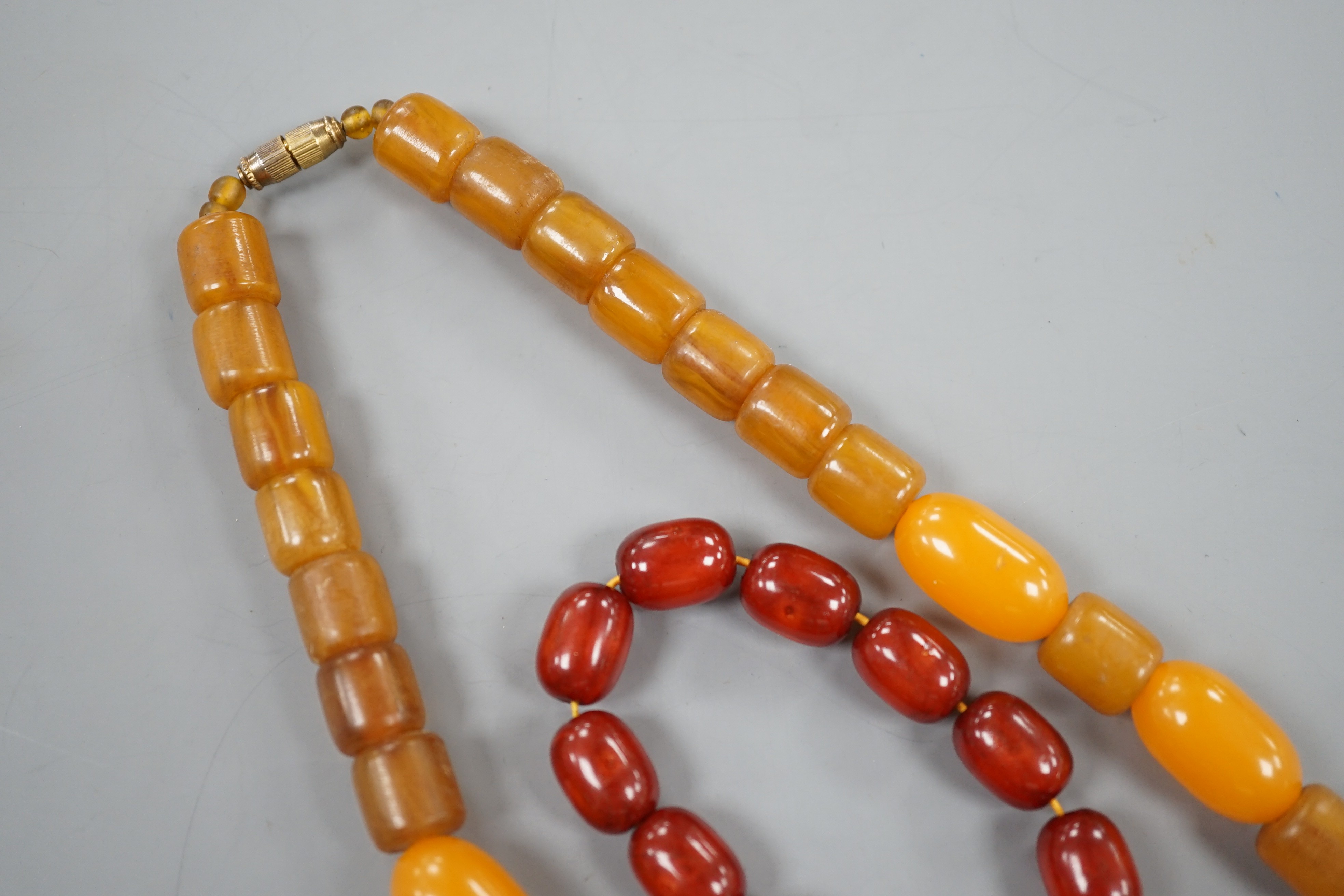 An amberoid expanding bracelet, and an amberoid necklace, 46cm.